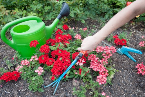 Gardener working safely with tools in a maintained outdoor space