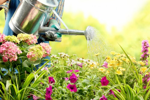 Professional gardeners carrying out agreed maintenance work in a private garden